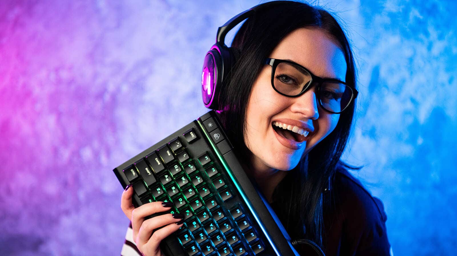 A PC Gamer holding a keyboard